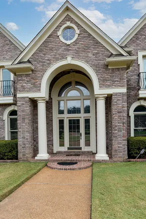 a front view of a house with garden