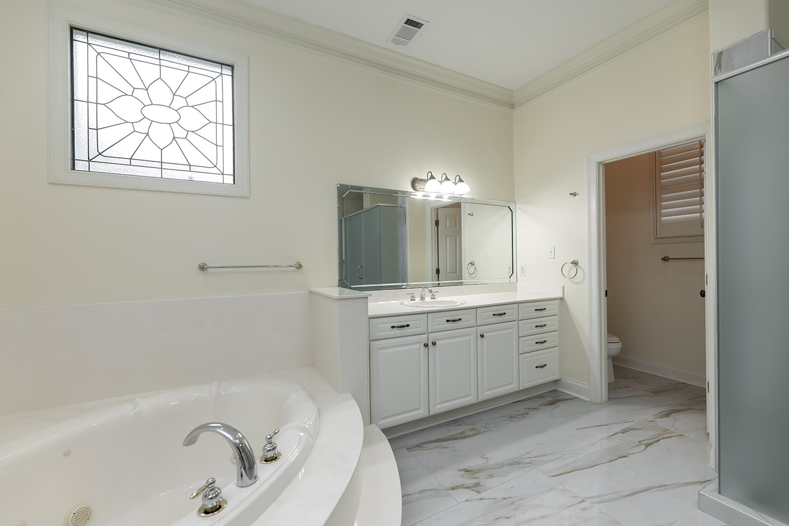 9390 Mayfield Road South Collierville, TN 38017 - Photo 24 of 40 a bathroom with a tub sink and mirror