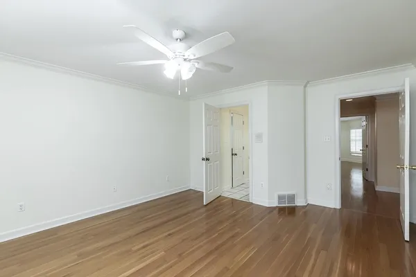 a spacious bathroom with a shower a sink and a mirror