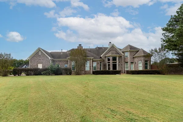 a front view of house with yard and green space