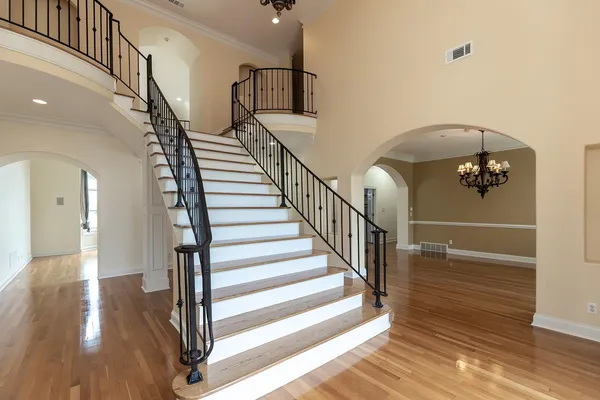 a view of entryway and hall with wooden floor