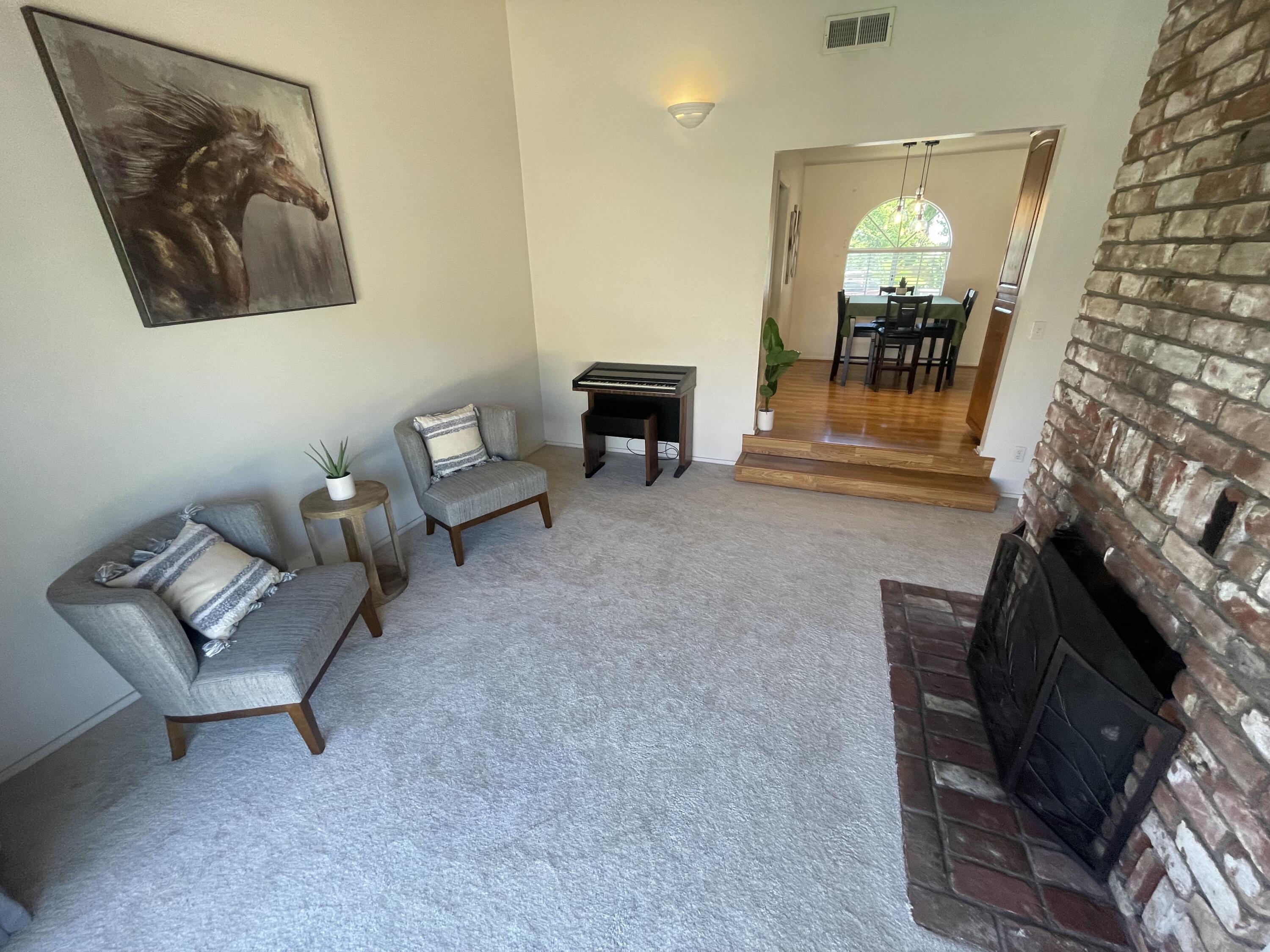 4170 Meander Drive Redding, CA 96001 - Photo 16 of 50 a living room with furniture and a fireplace