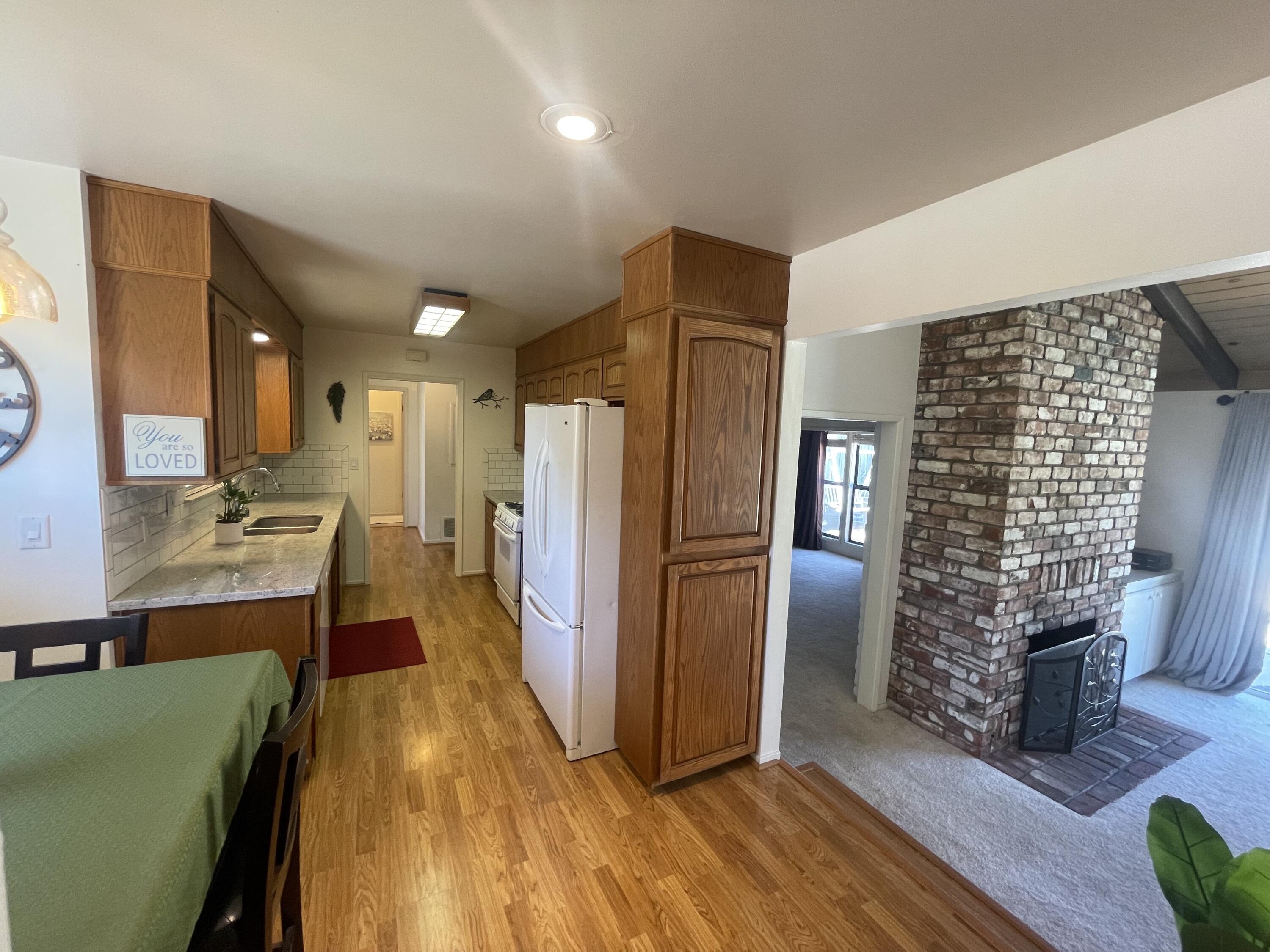 4170 Meander Drive Redding, CA 96001 - Photo 19 of 50 a kitchen with stainless steel appliances kitchen island granite countertop a refrigerator and a stove top oven
