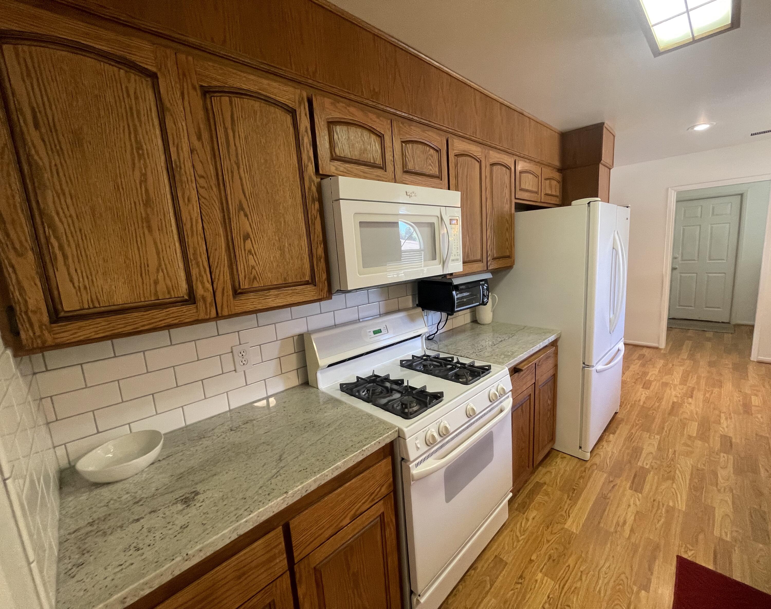 4170 Meander Drive Redding, CA 96001 - Photo 20 of 50 a kitchen with stainless steel appliances granite countertop a sink stove and refrigerator