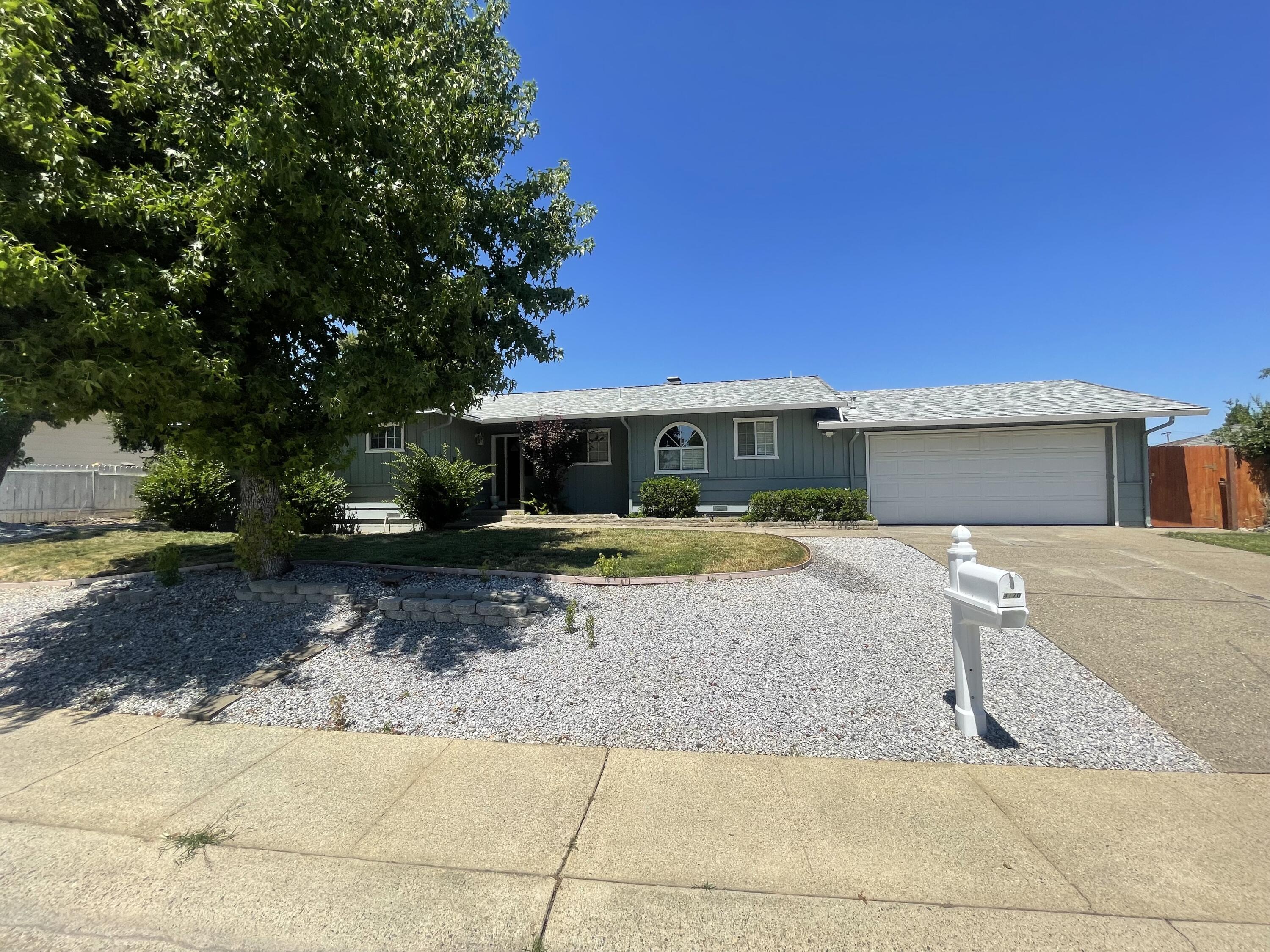 4170 Meander Drive Redding, CA 96001 - Photo 2 of 50 a front view of a house with a yard and a garage
