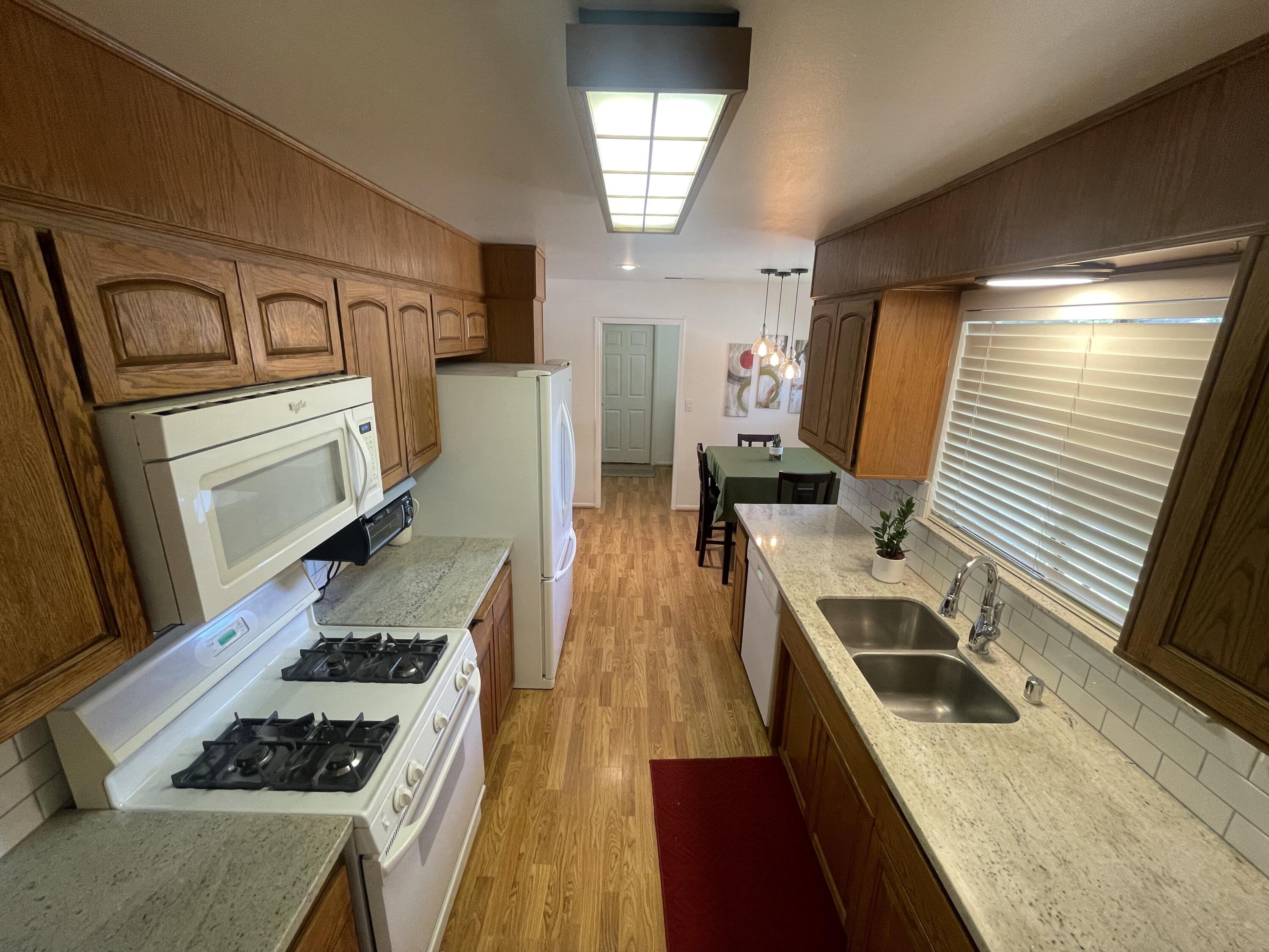 4170 Meander Drive Redding, CA 96001 - Photo 22 of 50 a kitchen that has a lot of cabinets in it