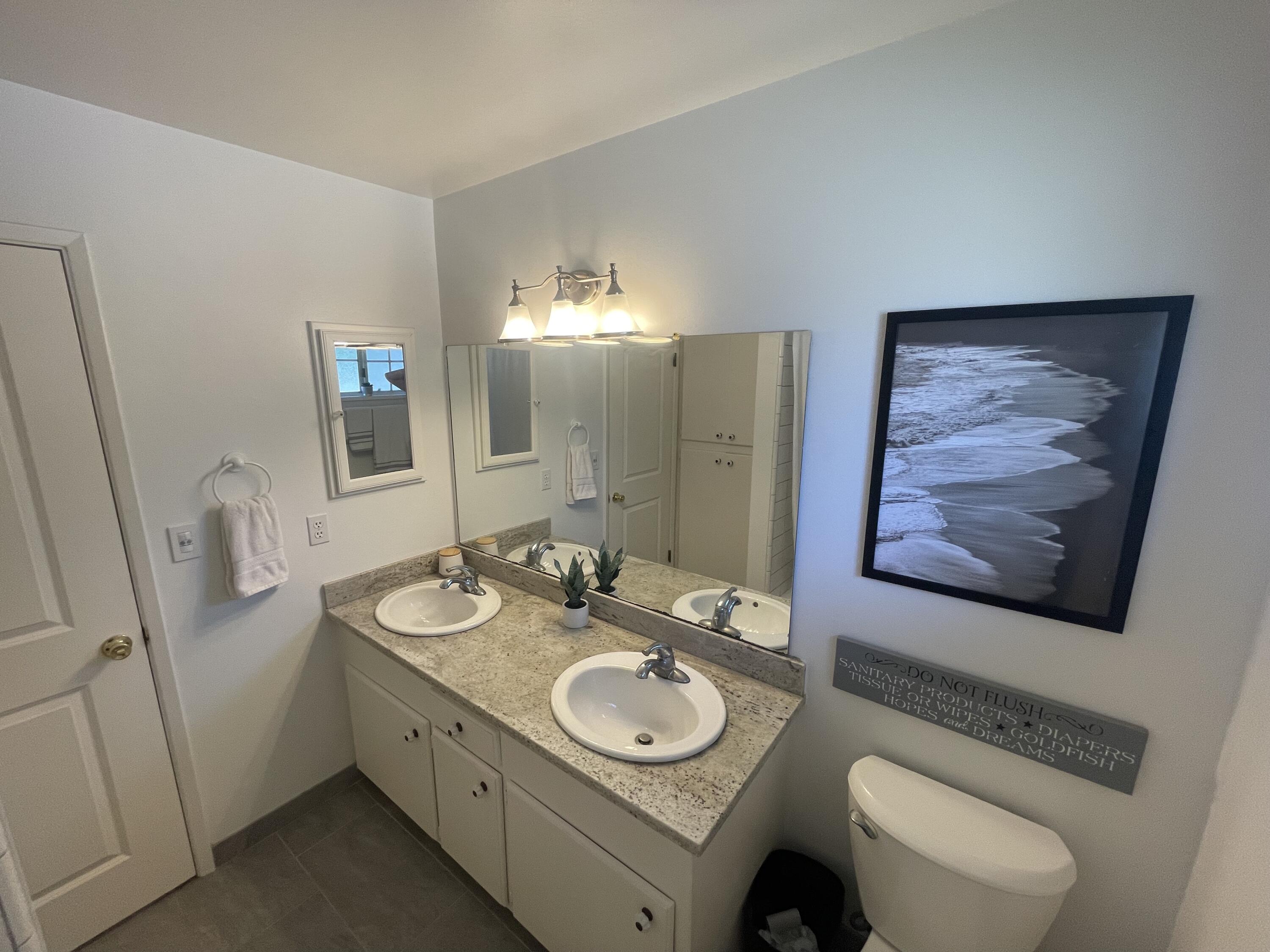 4170 Meander Drive Redding, CA 96001 - Photo 26 of 50 a bathroom with a toilet a sink and mirror
