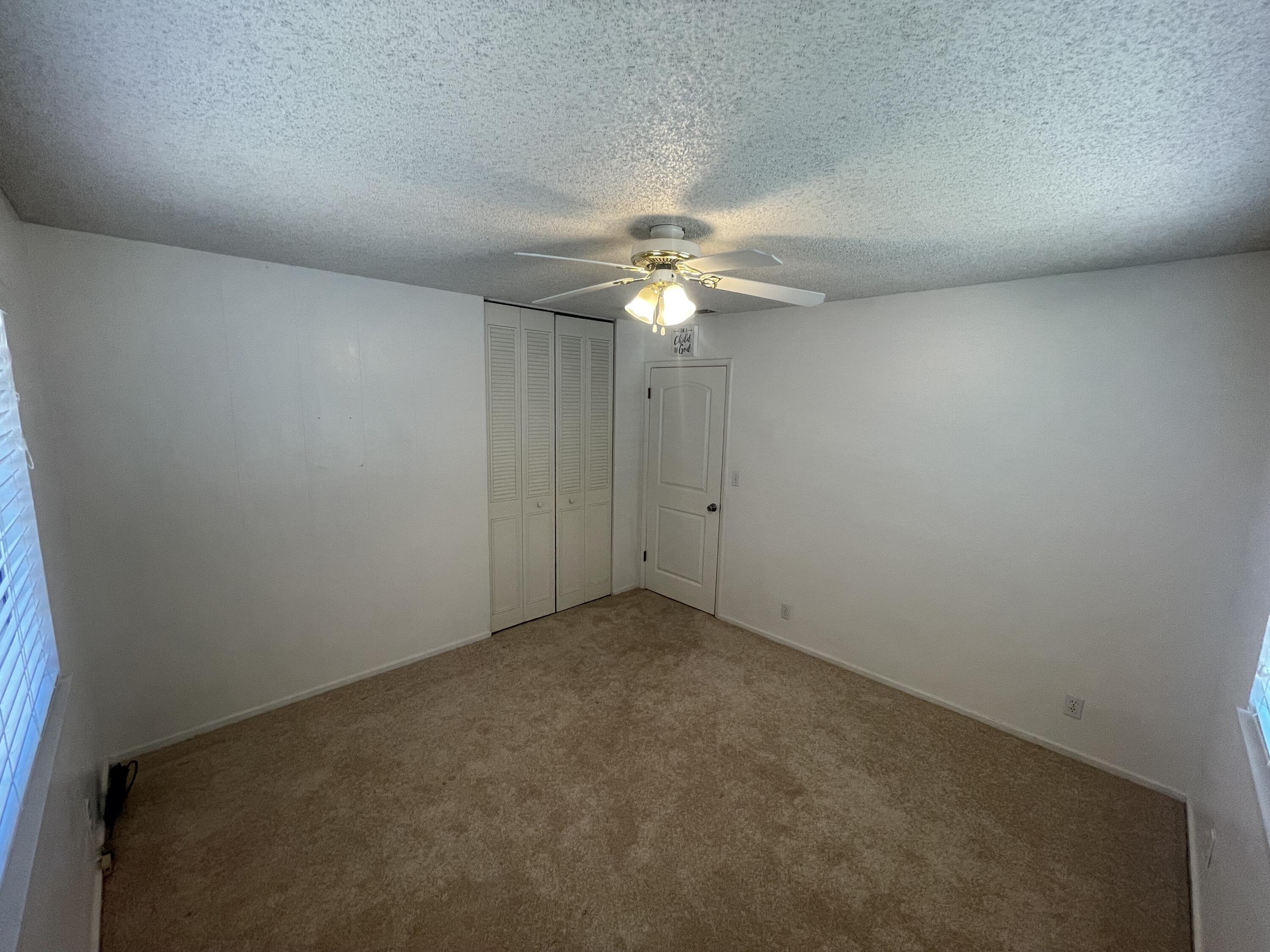 4170 Meander Drive Redding, CA 96001 - Photo 29 of 50 an empty room with a chandelier fan and closet