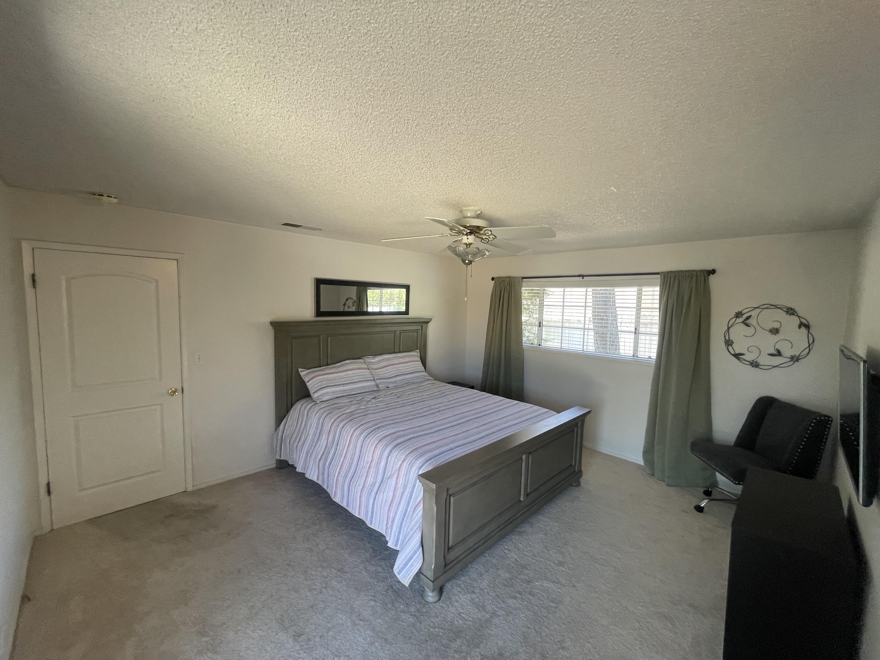 4170 Meander Drive Redding, CA 96001 - Photo 32 of 50 a spacious bedroom with a bed and window