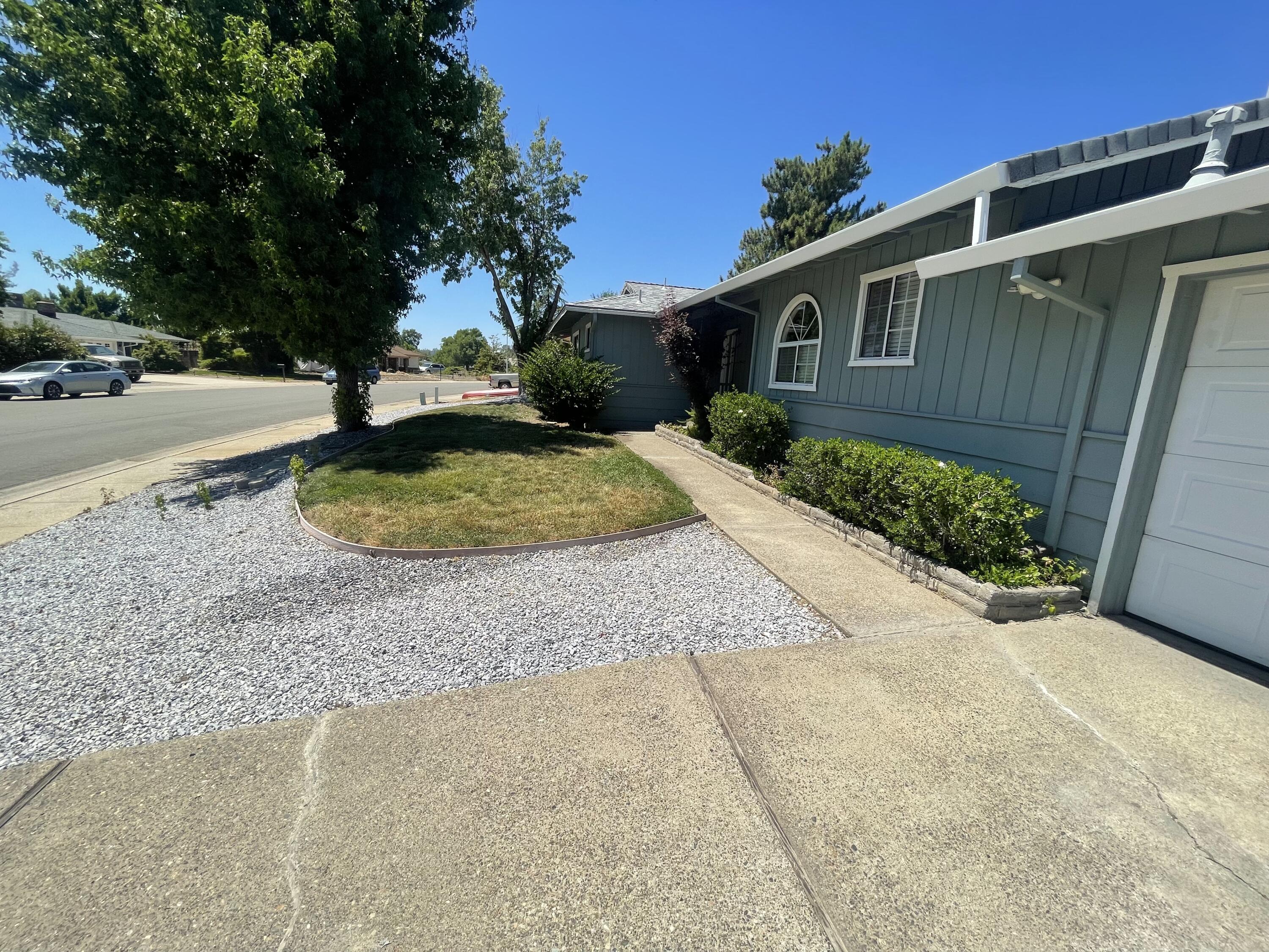 4170 Meander Drive Redding, CA 96001 - Photo 7 of 50 a backyard of a house with a yard and outdoor seating