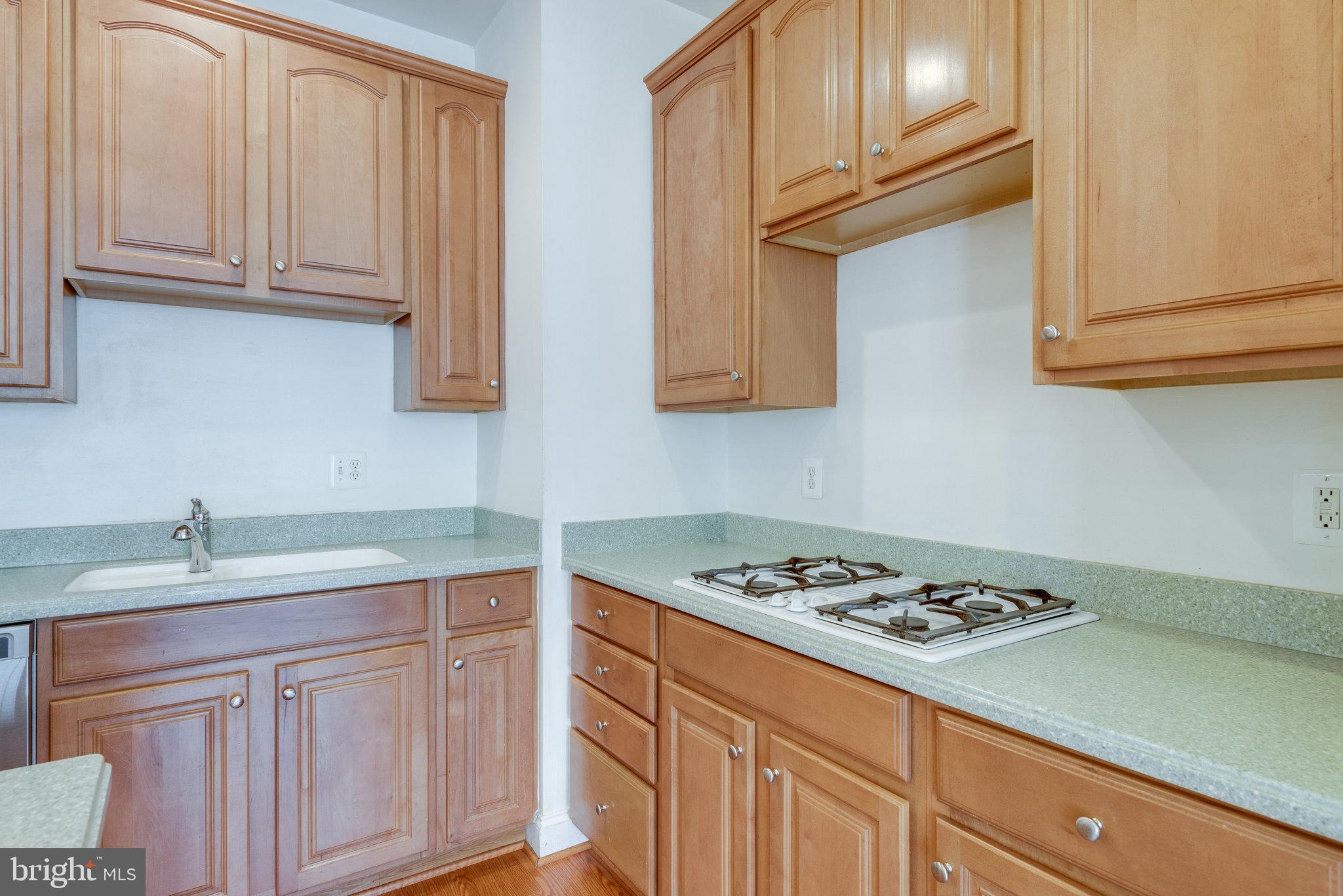 6884 Witton Circle Gainesville, VA 20155 - Photo 12 of 40 a kitchen with stainless steel appliances granite countertop a sink stove and cabinets
