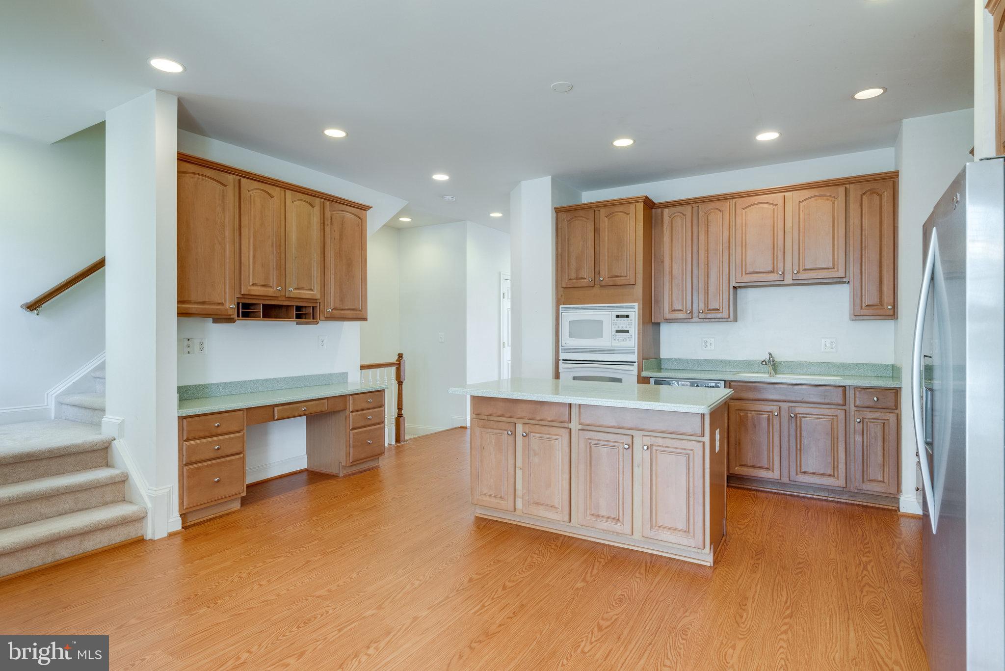 6884 Witton Circle Gainesville, VA 20155 - Photo 13 of 40 a kitchen with stainless steel appliances granite countertop a stove a sink and a refrigerator