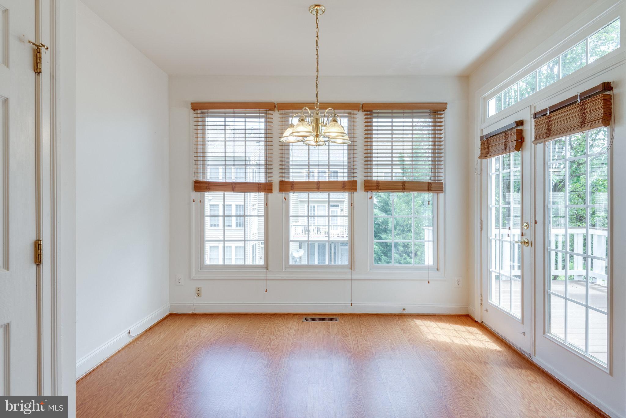 6884 Witton Circle Gainesville, VA 20155 - Photo 15 of 40 a view of an empty room with wooden floor and a window
