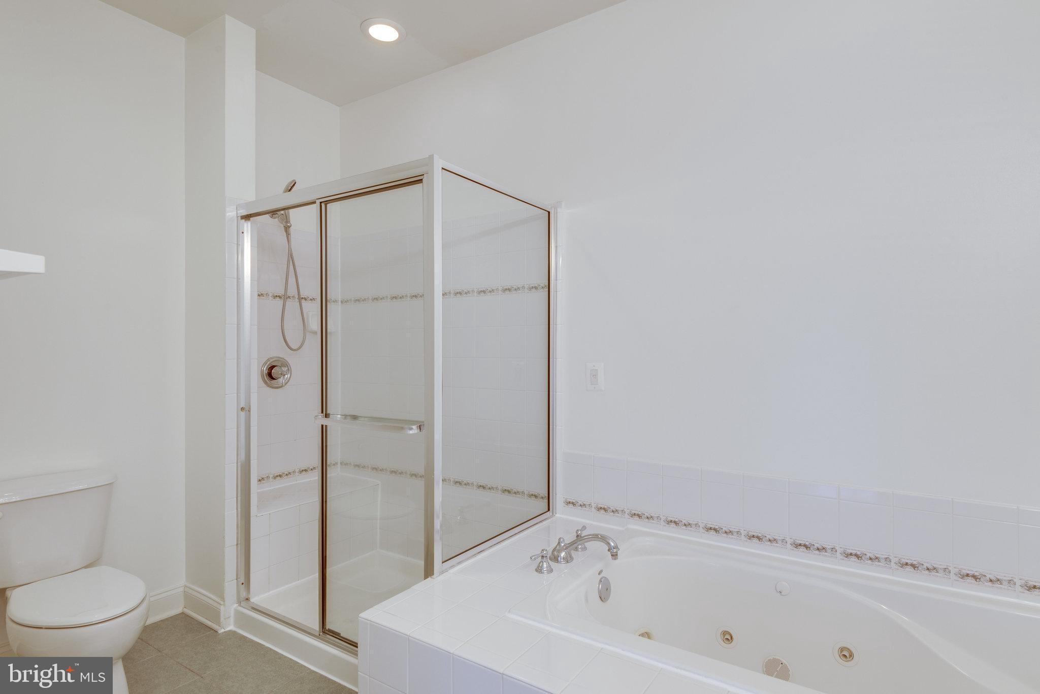 6884 Witton Circle Gainesville, VA 20155 - Photo 19 of 40 a bathroom with a bathtub and a toilet