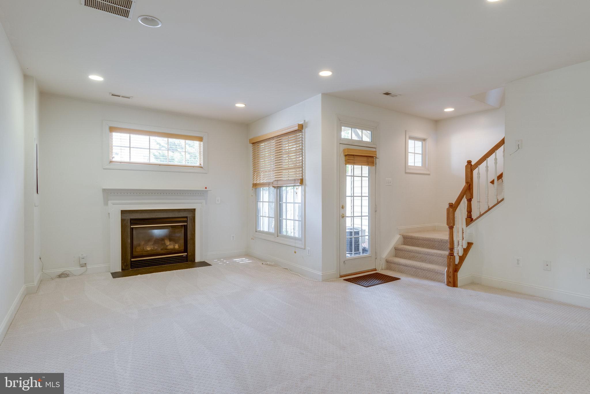 6884 Witton Circle Gainesville, VA 20155 - Photo 24 of 40 a view of an empty room with fireplace and a window