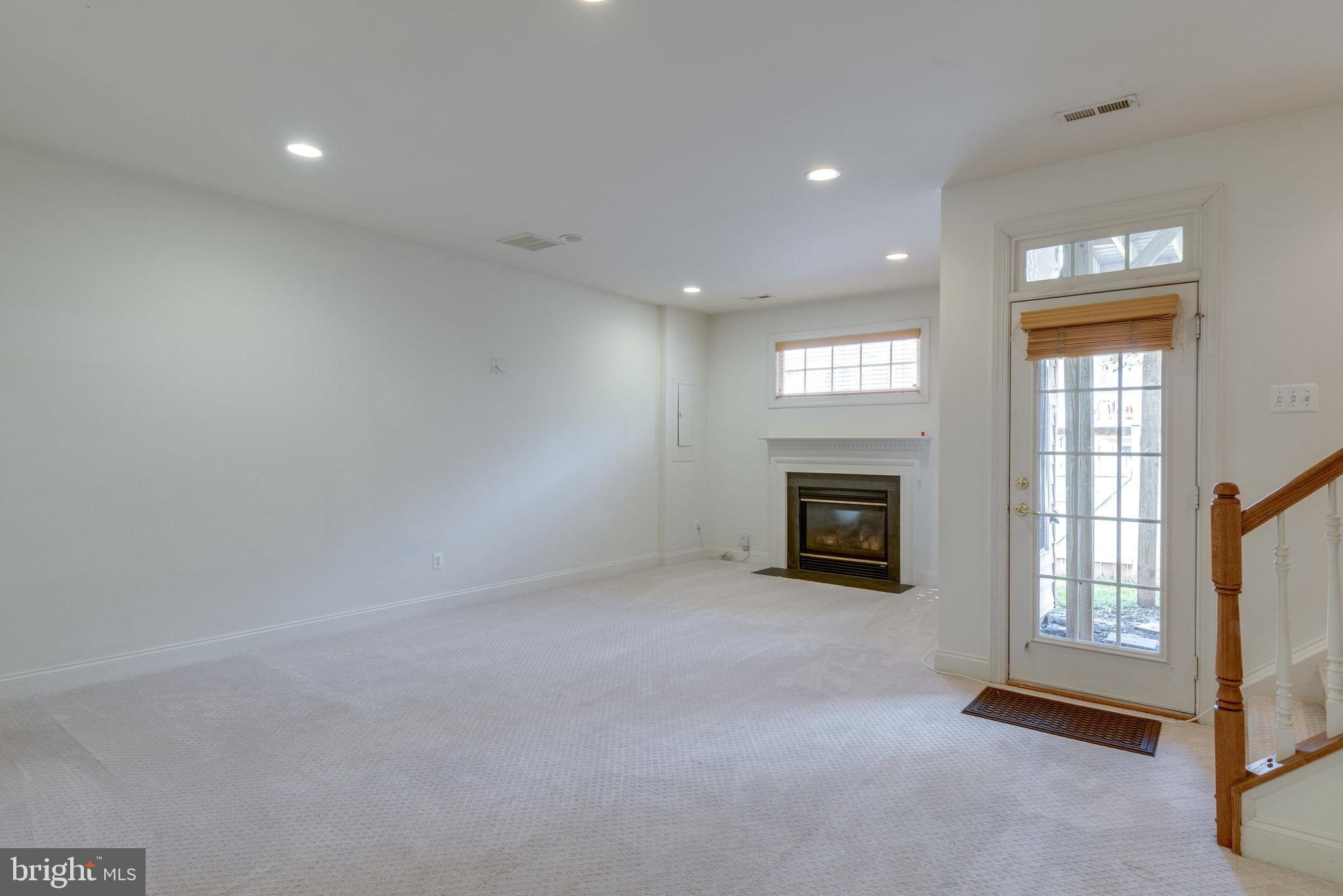 6884 Witton Circle Gainesville, VA 20155 - Photo 26 of 40 an empty room with windows and fireplace
