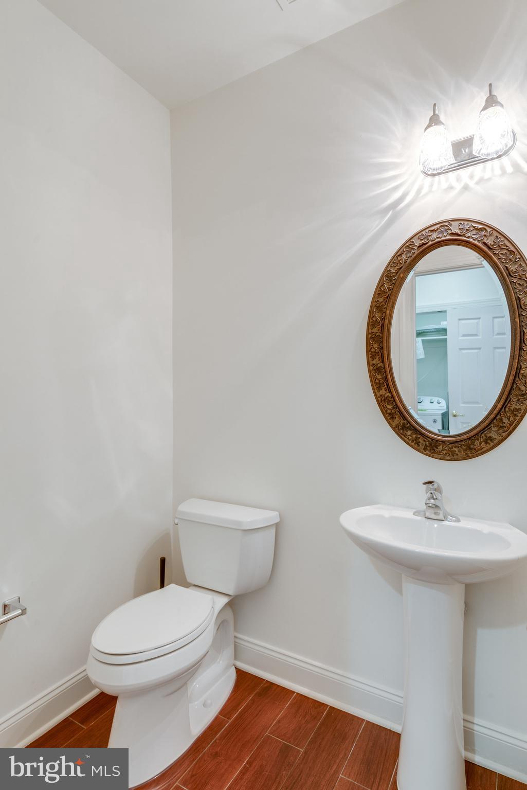 6884 Witton Circle Gainesville, VA 20155 - Photo 27 of 40 a bathroom with a sink a toilet and a mirror