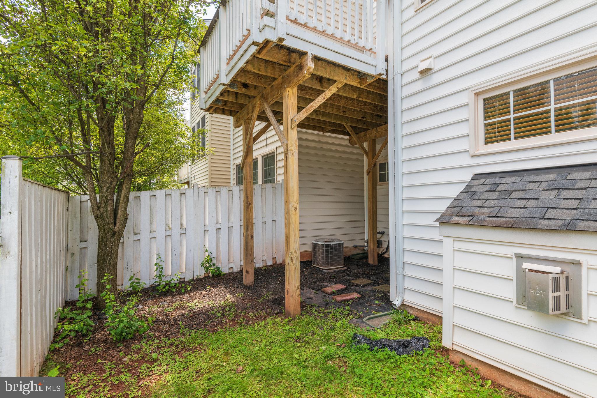 6884 Witton Circle Gainesville, VA 20155 - Photo 34 of 40 a view of backyard with a chair and potted plants