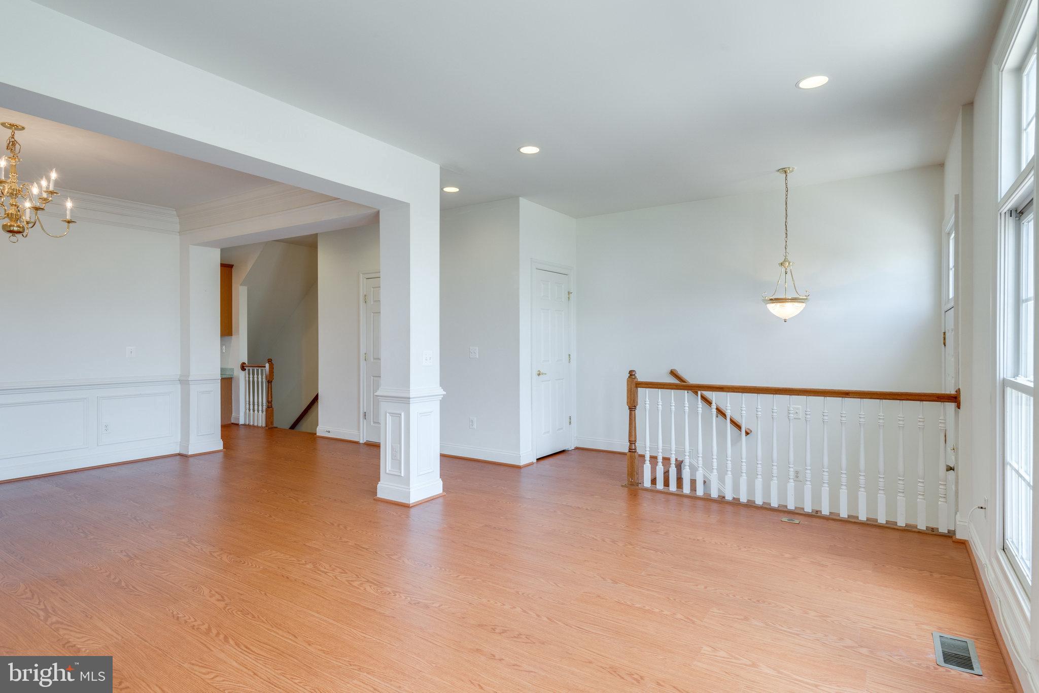 6884 Witton Circle Gainesville, VA 20155 - Photo 5 of 40 wooden floor in an empty room with a window