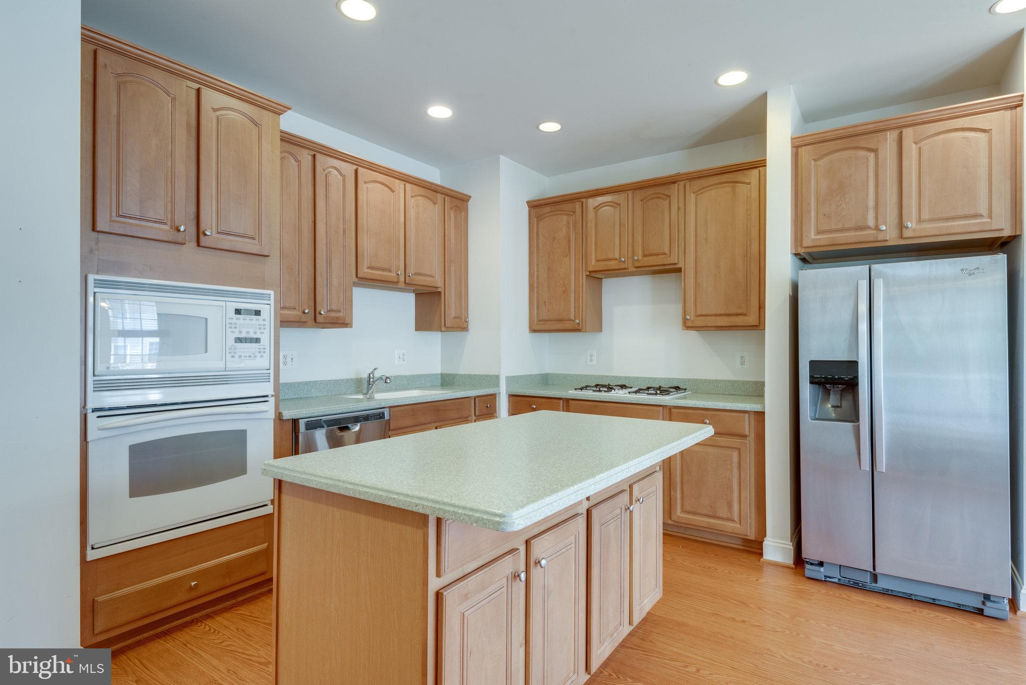 6884 Witton Circle Gainesville, VA 20155 - Photo 9 of 40 a kitchen that has a sink cabinets counter space and appliances