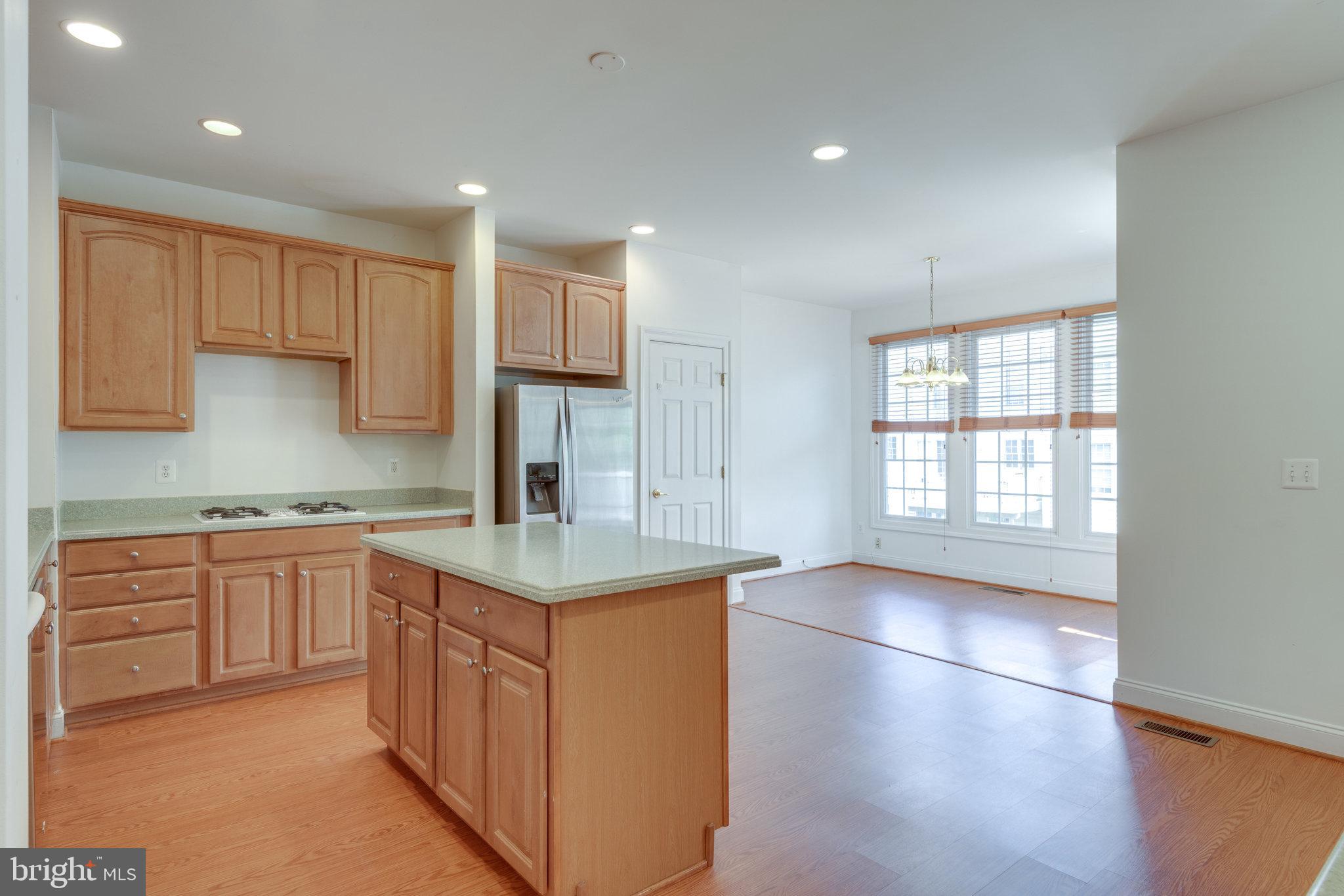 6884 Witton Circle Gainesville, VA 20155 - Photo 10 of 40 a kitchen with stainless steel appliances granite countertop a sink stove and cabinets