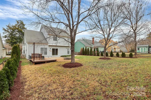 a view of a yard with a house and a tree