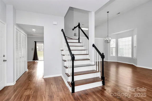 a view of entryway with wooden floor and stairs