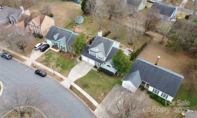 an aerial view of a house with a yard and lake view