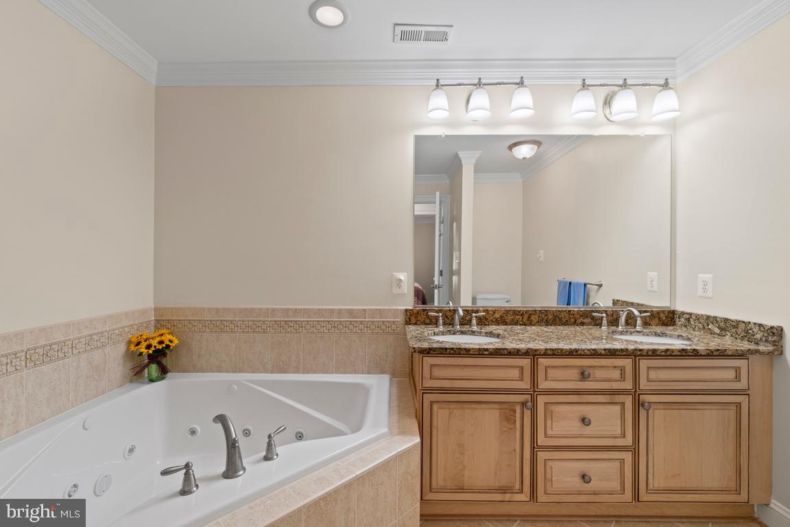 8100 Main Creek Road Pasadena, MD 21122 - Photo 25 of 40 Master bathroom tub and double vanities