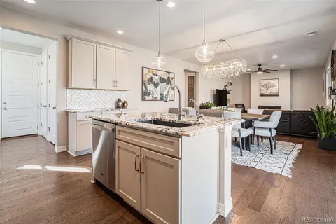 a kitchen with a sink cabinets and wooden floor