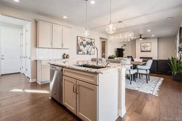a kitchen with a sink cabinets and wooden floor