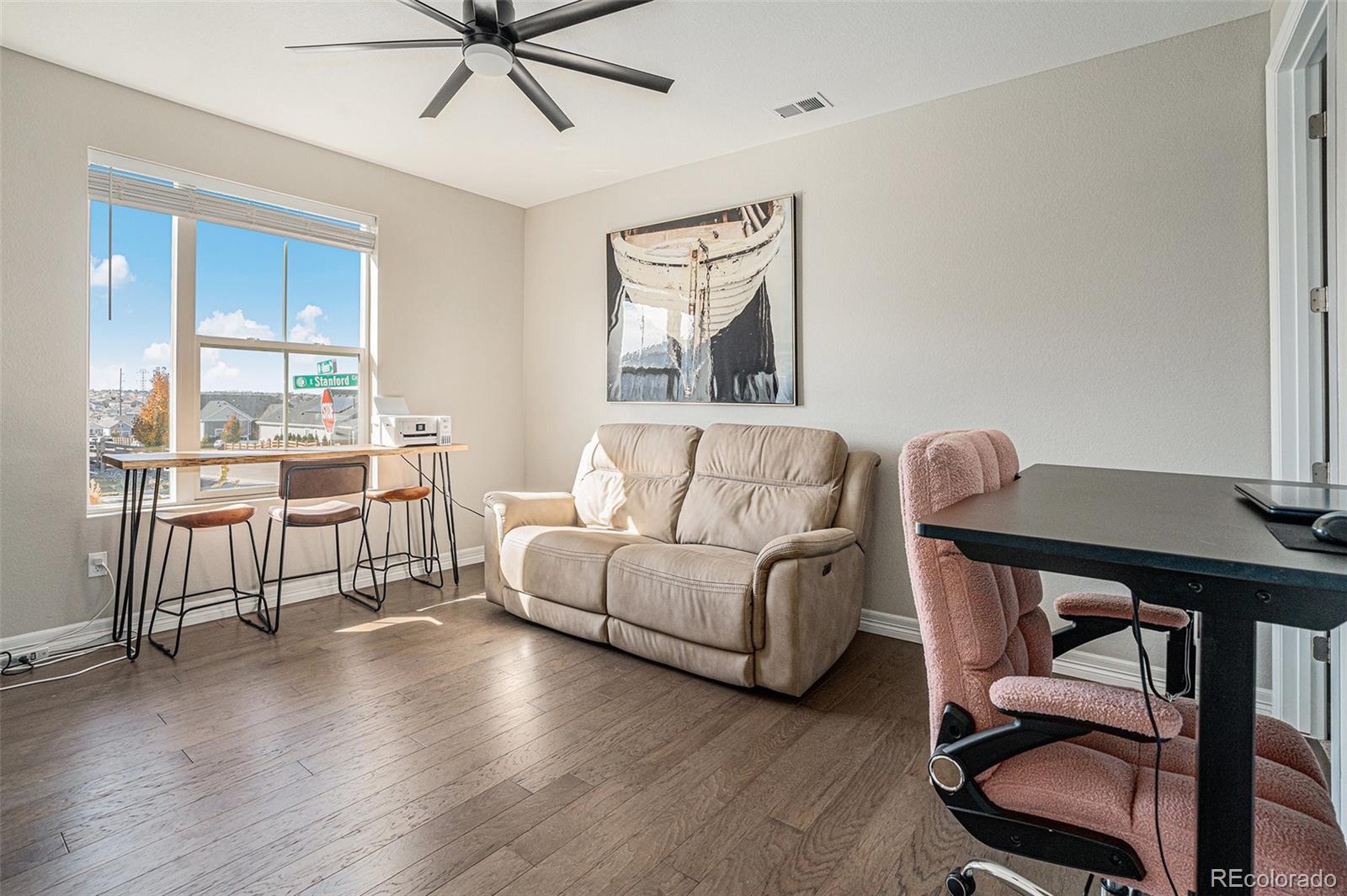 22011 East Stanford Circle Aurora, CO 80015 - Photo 14 of 43 a living room with furniture and a large window