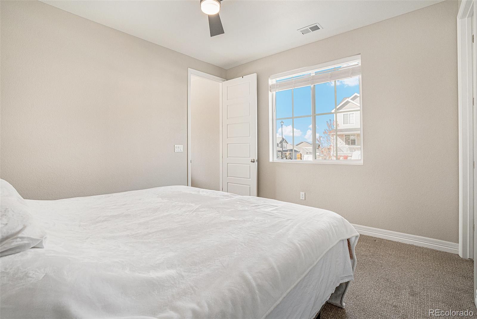 22011 East Stanford Circle Aurora, CO 80015 - Photo 16 of 43 a bedroom with a bed and a window