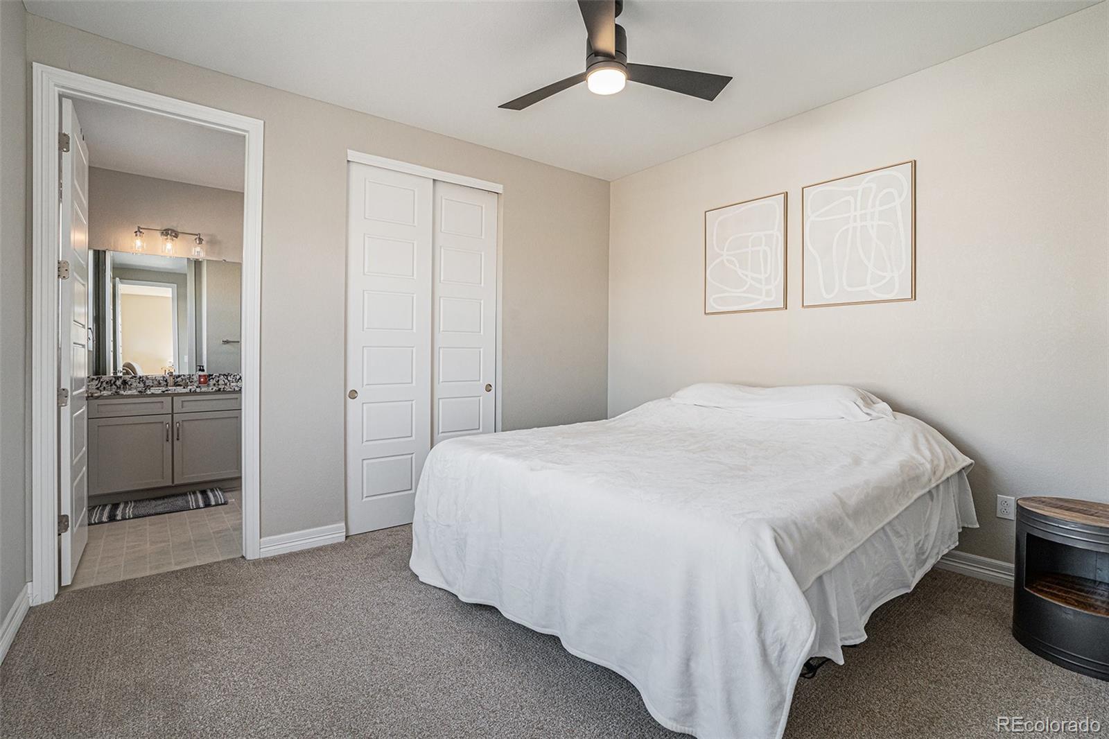 22011 East Stanford Circle Aurora, CO 80015 - Photo 17 of 43 a bedroom with a bed and a view of bathroom
