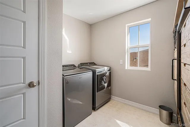 a kitchen with a refrigerator and a stove