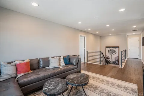 a living room with furniture and a wooden floor