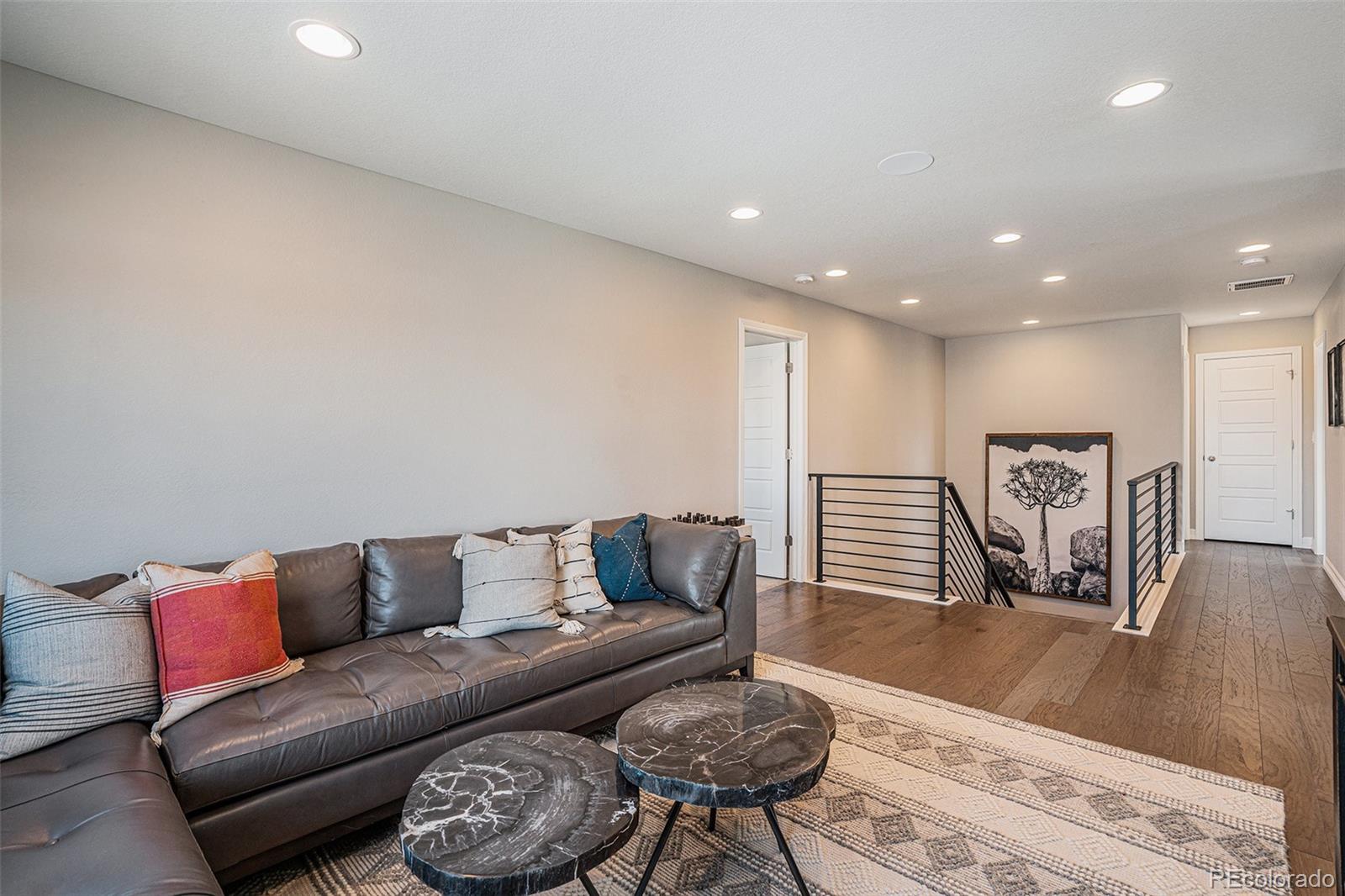 22011 East Stanford Circle Aurora, CO 80015 - Photo 22 of 43 a living room with furniture and a wooden floor