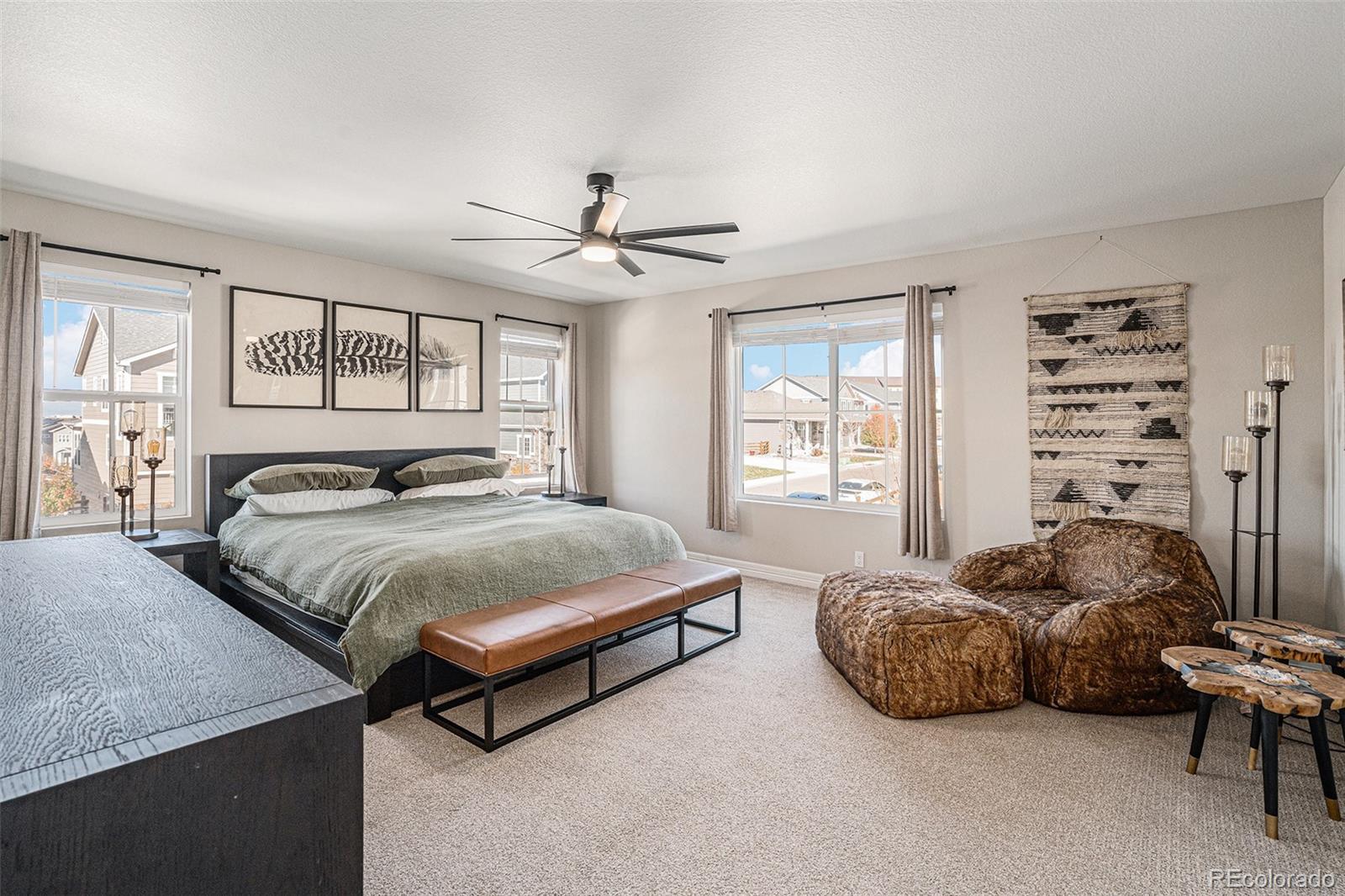22011 East Stanford Circle Aurora, CO 80015 - Photo 24 of 43 a bedroom with a bed and a chandelier