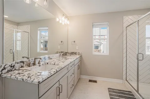 a bathroom with a sink double vanity and a mirror