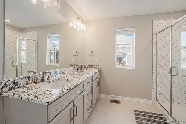 a bathroom with a sink double vanity and a mirror