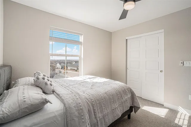 a bedroom with a bed and a large window