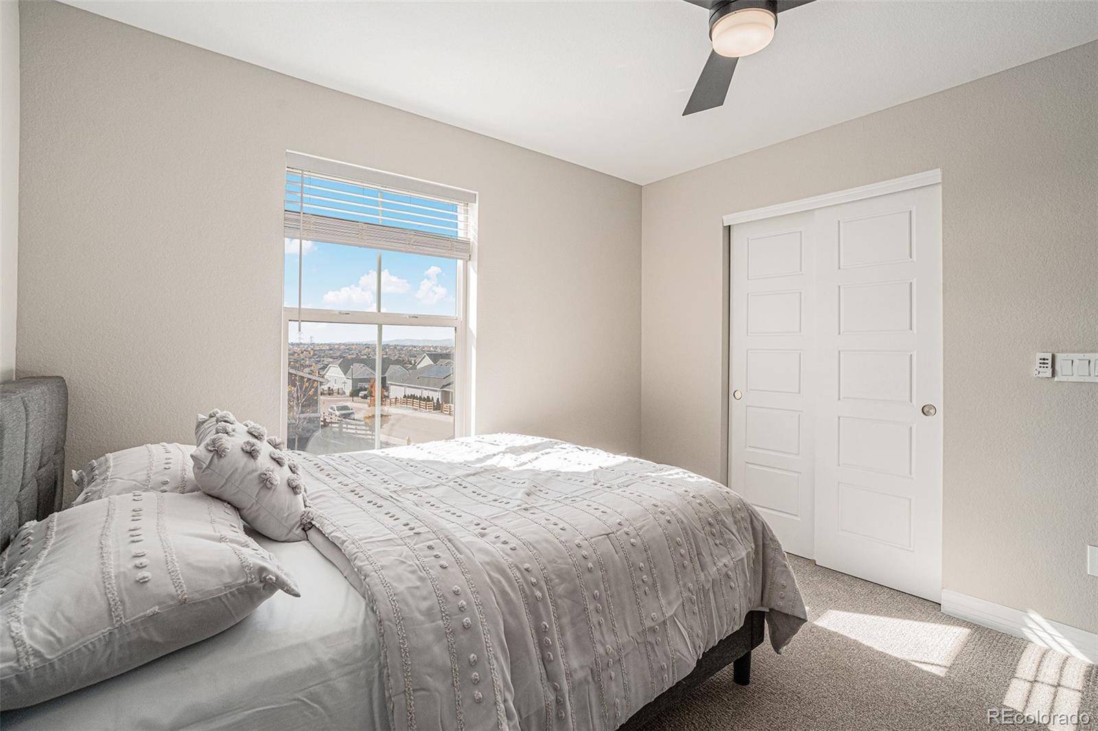 22011 East Stanford Circle Aurora, CO 80015 - Photo 29 of 43 a bedroom with a bed and a window