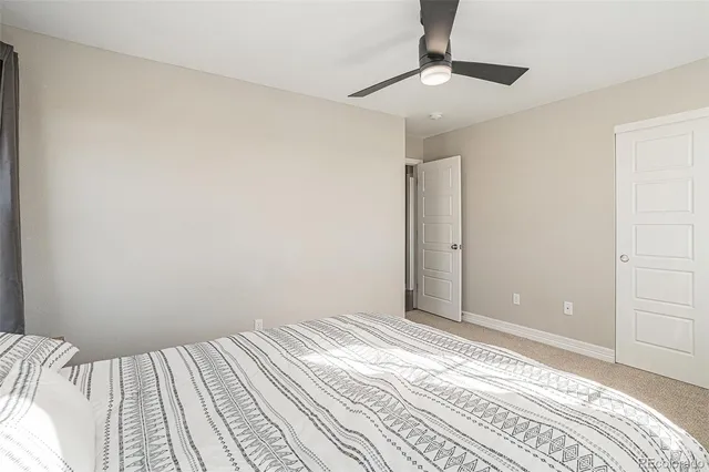 a bedroom with a bed a desk and chair