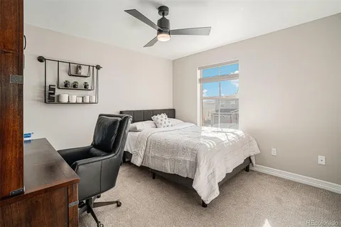 a bedroom with a bed window and a table