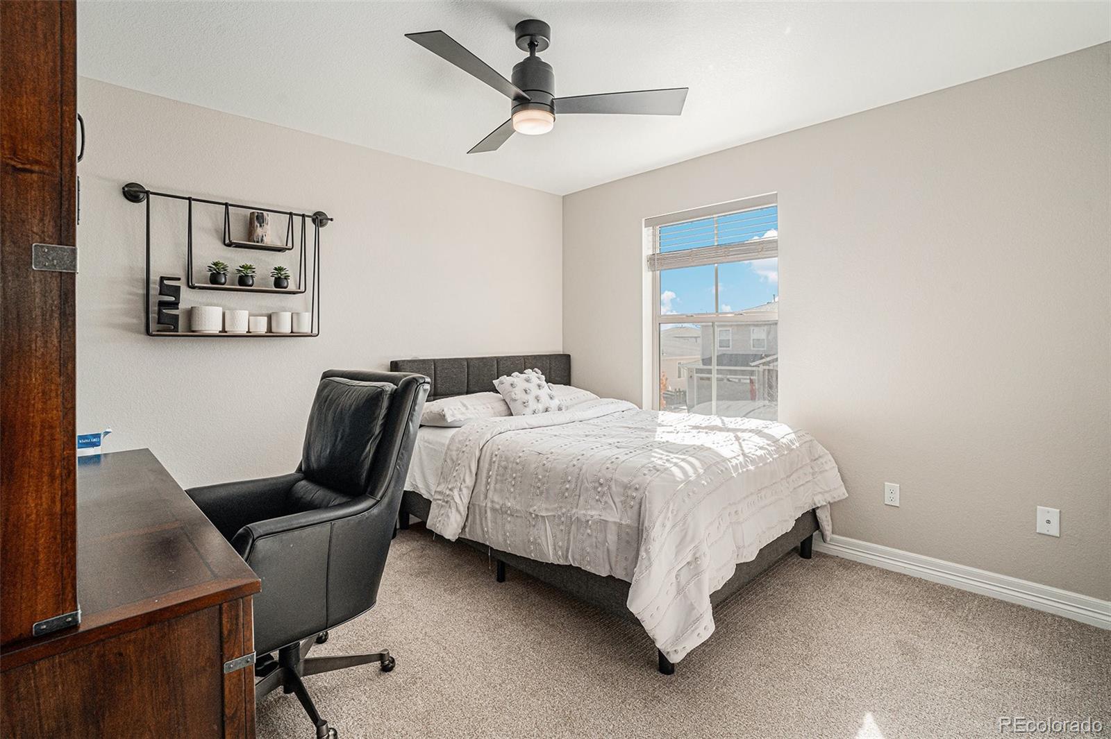 22011 East Stanford Circle Aurora, CO 80015 - Photo 32 of 43 a bedroom with a bed a desk and chair