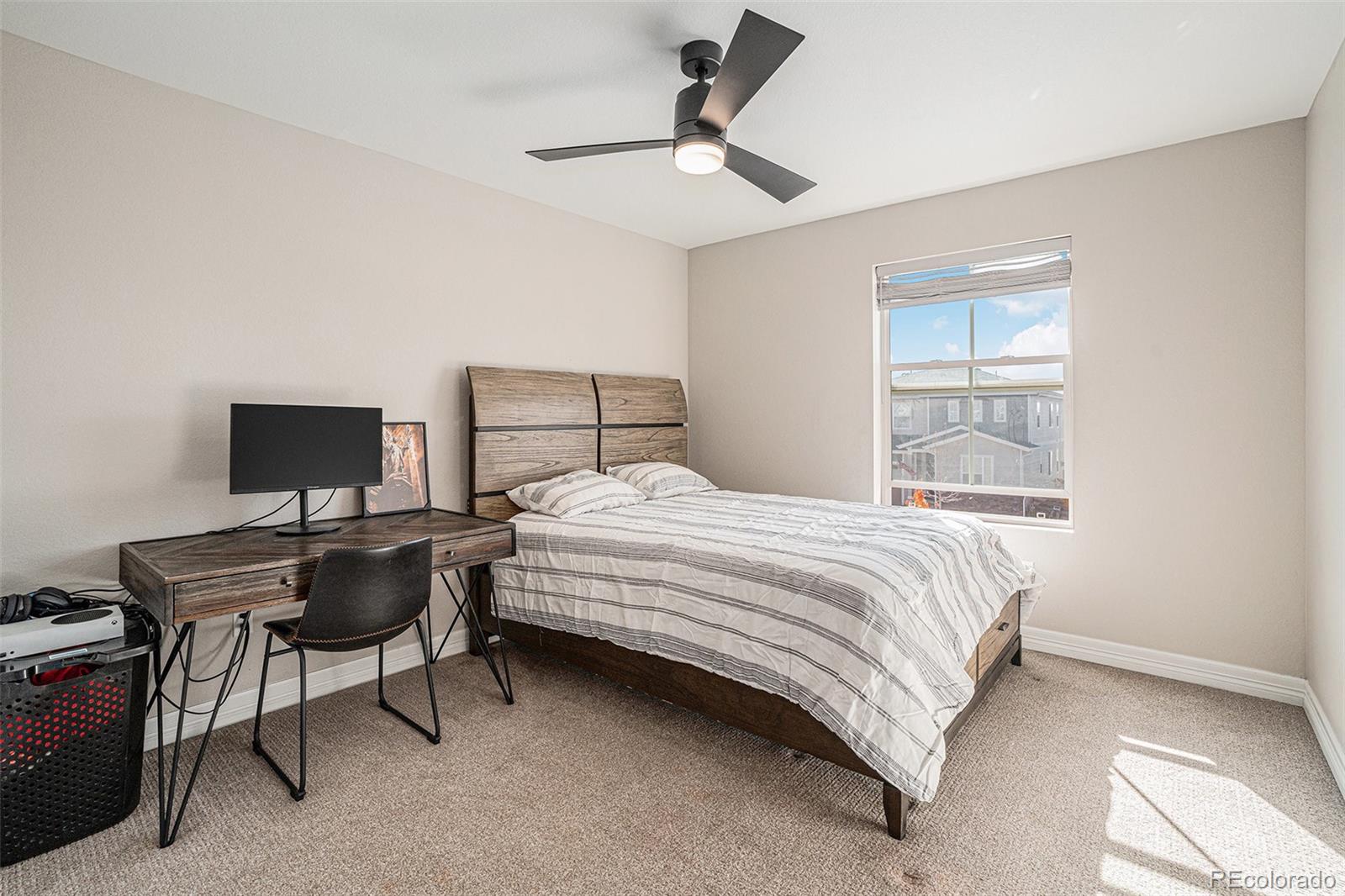 22011 East Stanford Circle Aurora, CO 80015 - Photo 33 of 43 a bedroom with a bed window and a table
