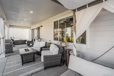 a view of a house with backyard porch and outdoor seating