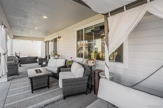 a view of a house with backyard porch and outdoor seating