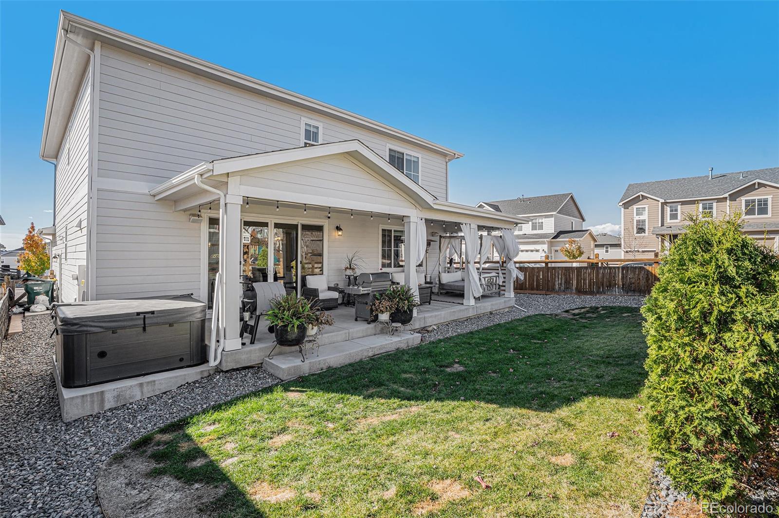 22011 East Stanford Circle Aurora, CO 80015 - Photo 40 of 43 a view of a patio with table and chairs potted plants and floor to ceiling window