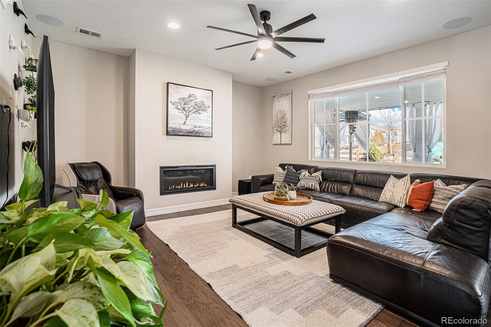 22011 East Stanford Circle Aurora, CO 80015 - Photo 4 of 43 a living room with furniture and a fireplace